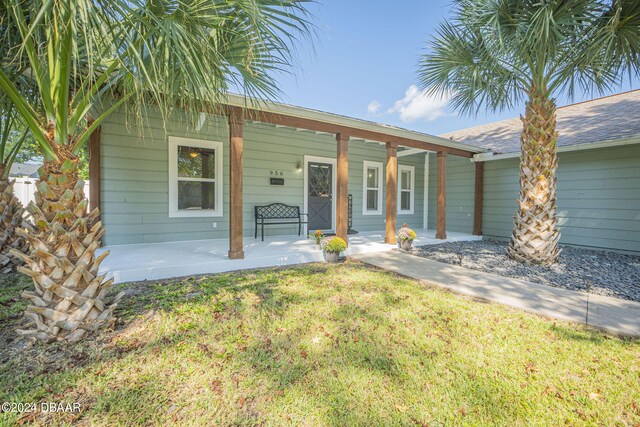 exterior space with a porch and a lawn