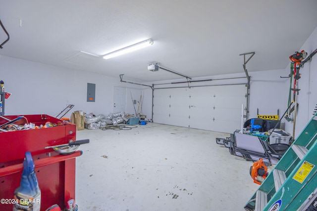 garage with a garage door opener and electric panel