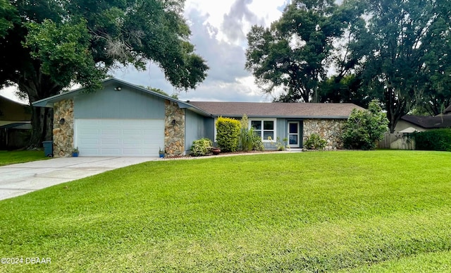 single story home featuring a front lawn and a garage