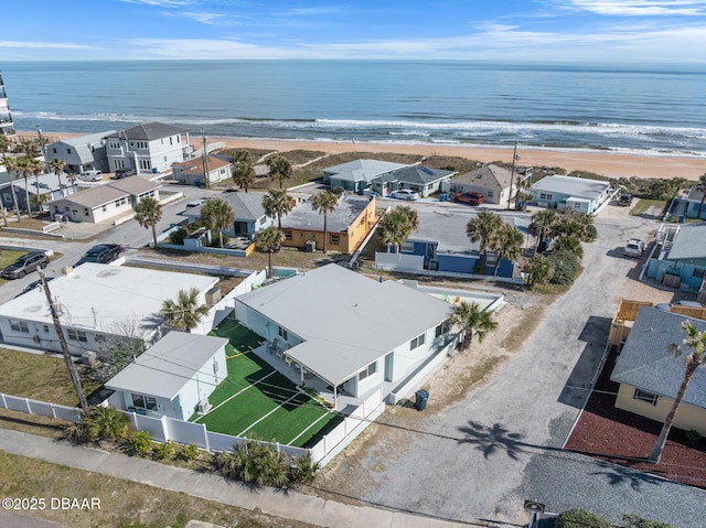 aerial view with a residential view, a water view, and a beach view