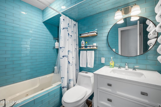 bathroom featuring toilet, tiled shower / bath combo, vanity, tile walls, and tasteful backsplash