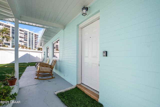 entrance to property featuring fence