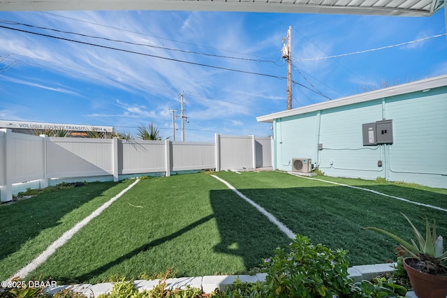 view of yard with ac unit and fence