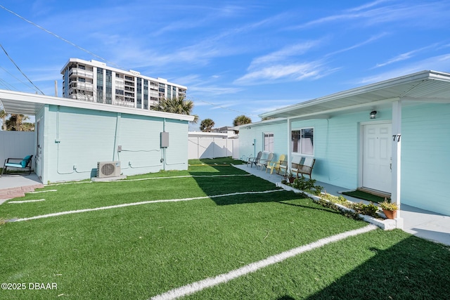 view of yard with ac unit and fence