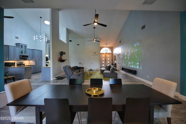 1948 Spruce Creek Lndg, Port Orange, FL 32128 - dining space featuring baseboards, high vaulted ceiling, visible vents, and ceiling fan with notable chandelier