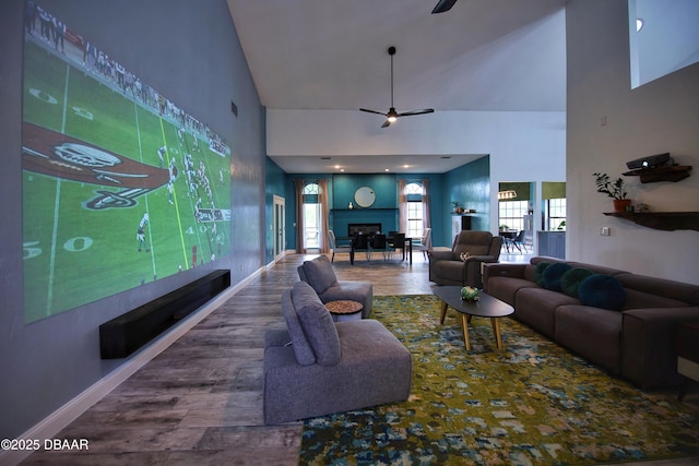 1948 Spruce Creek Lndg, Port Orange, FL 32128 - living room featuring a fireplace, high vaulted ceiling, a ceiling fan, baseboards, and wood finished floors