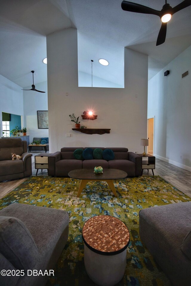 1948 Spruce Creek Lndg, Port Orange, FL 32128 - living area featuring visible vents, ceiling fan, baseboards, wood finished floors, and high vaulted ceiling