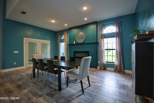1948 Spruce Creek Lndg, Port Orange, FL 32128 - dining room featuring visible vents, wood finished floors, a fireplace, and recessed lighting