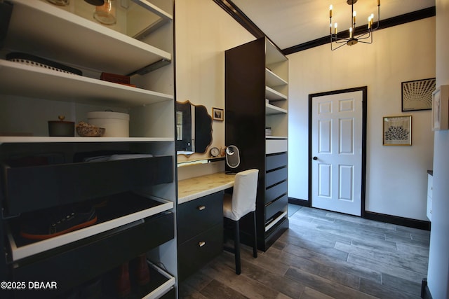 1948 Spruce Creek Lndg, Port Orange, FL 32128 - office featuring built in desk, a chandelier, baseboards, ornamental molding, and dark wood finished floors