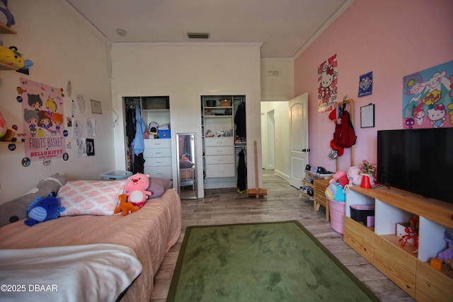 1948 Spruce Creek Lndg, Port Orange, FL 32128 - bedroom featuring wood finished floors, visible vents, and crown molding