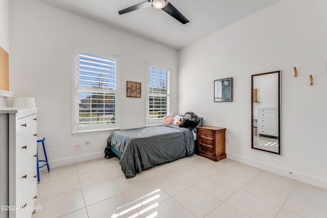 bedroom with ceiling fan and light tile patterned flooring