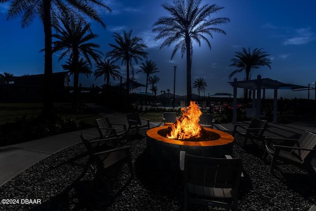 patio at night featuring a fire pit