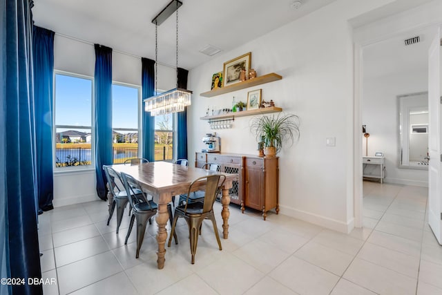 tiled dining space featuring a water view