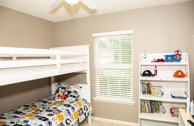 bedroom featuring ceiling fan and baseboards