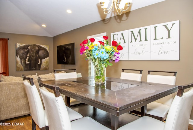 dining area featuring a chandelier, lofted ceiling, wood finished floors, and recessed lighting