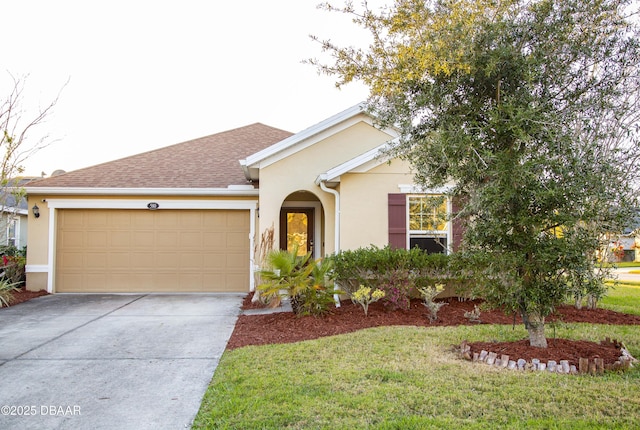 ranch-style home featuring driveway, roof with shingles, an attached garage, a front lawn, and stucco siding