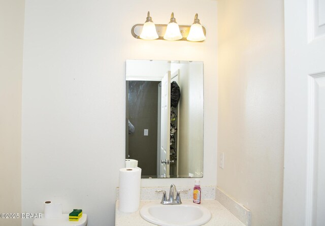 bathroom with toilet and vanity