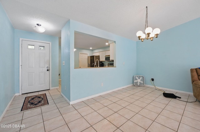 10 Lake Forest Cir N, Palm Coast, FL 32137 - foyer featuring light tile patterned floors, baseboards, and an inviting chandelier