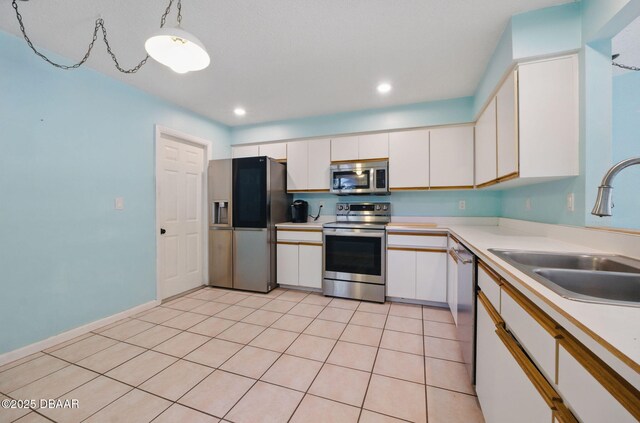 10 Lake Forest Cir N, Palm Coast, FL 32137 - kitchen with a sink, light countertops, appliances with stainless steel finishes, recessed lighting, and white cabinetry