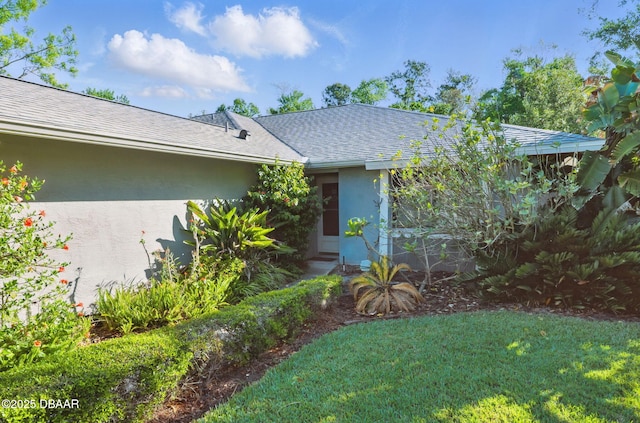 10 Lake Forest Cir N, Palm Coast, FL 32137 - view of front of home with a front yard, stucco siding, and a shingled roof