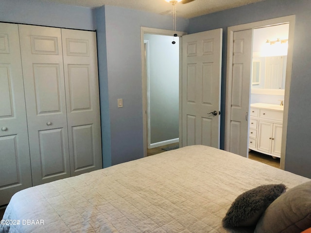 bedroom with a textured ceiling and connected bathroom