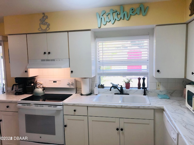 kitchen with white cabinetry, white appliances, sink, and tasteful backsplash