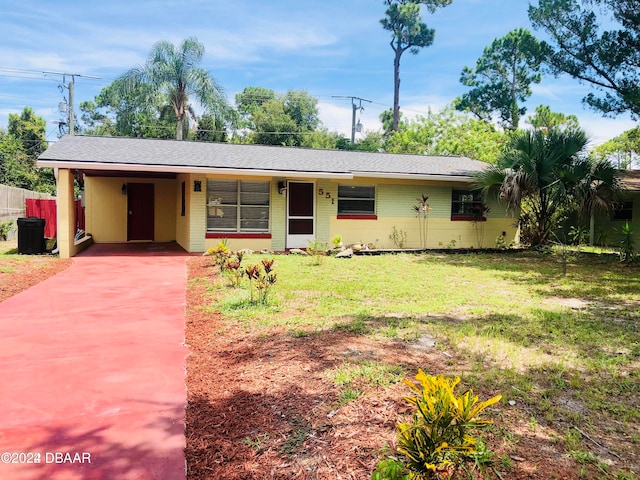 ranch-style house with a front lawn and a carport