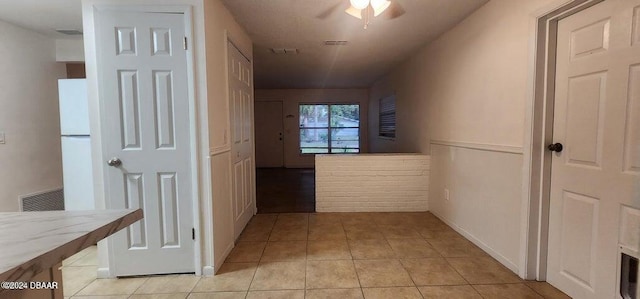 hall with light tile patterned floors