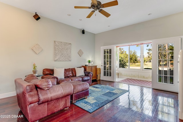 living area with baseboards, ceiling fan, and hardwood / wood-style floors