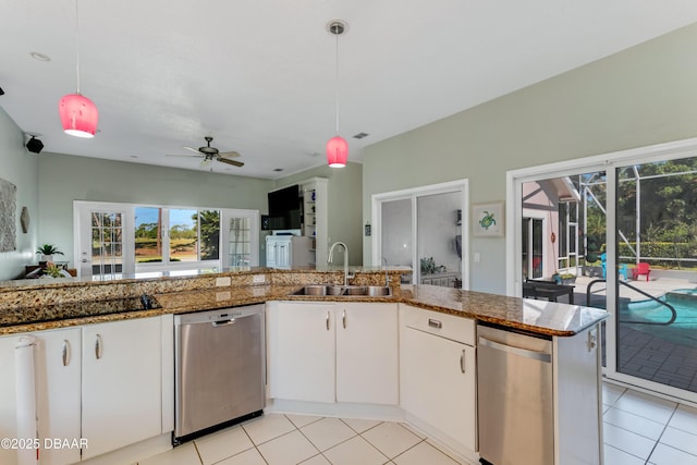 kitchen featuring ceiling fan, hanging light fixtures, a sink, light tile patterned floors, and stainless steel dishwasher