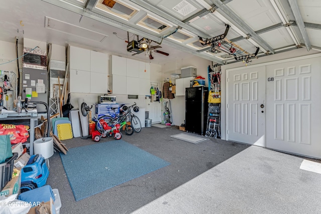 garage with freestanding refrigerator and a garage door opener