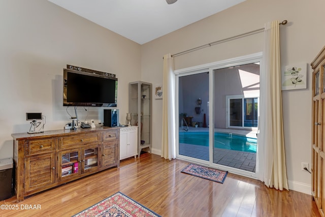 living room featuring baseboards and light wood-style flooring