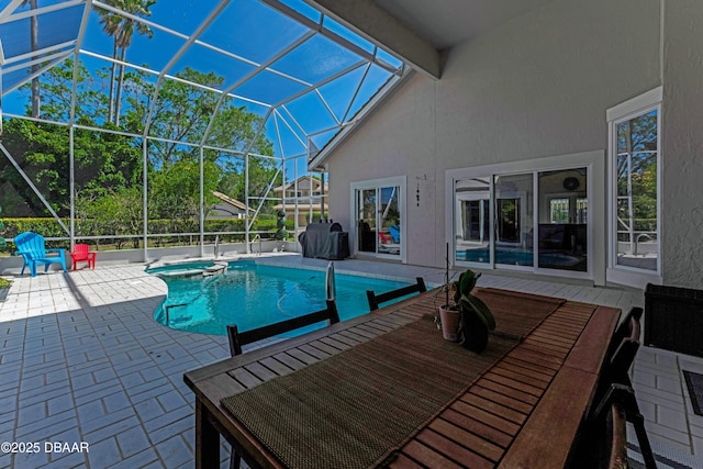 view of swimming pool with glass enclosure, a pool with connected hot tub, and a patio area