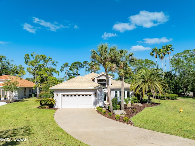 view of front of house featuring a tile roof, a garage, stucco siding, a front yard, and concrete driveway