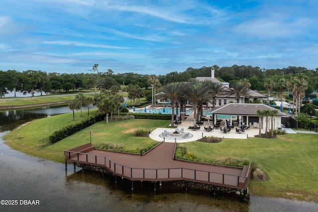 dock area with a lawn, a water view, a community pool, and a patio area