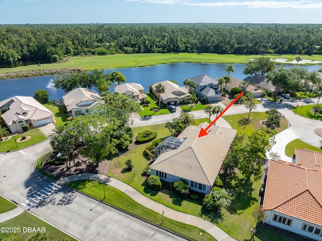bird's eye view with a water view, a view of trees, and a residential view