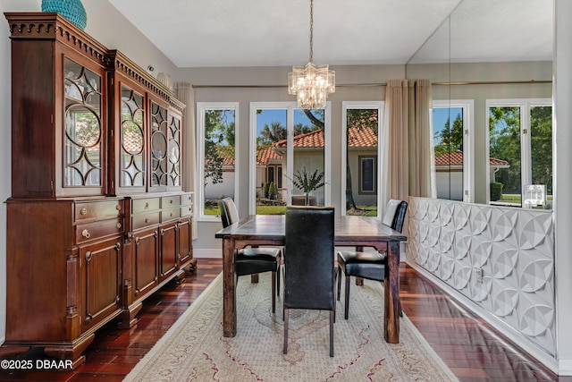 dining room with a chandelier and dark wood-type flooring