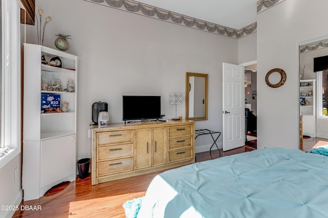 bedroom with light wood-type flooring and visible vents