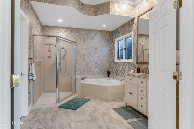 bathroom featuring a stall shower, wallpapered walls, a garden tub, and vanity