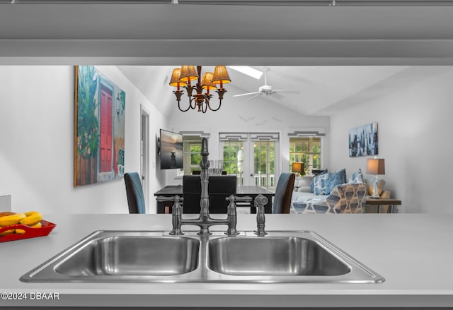 kitchen with vaulted ceiling with skylight, ceiling fan, and sink