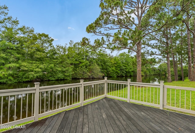 wooden deck featuring a yard and a water view