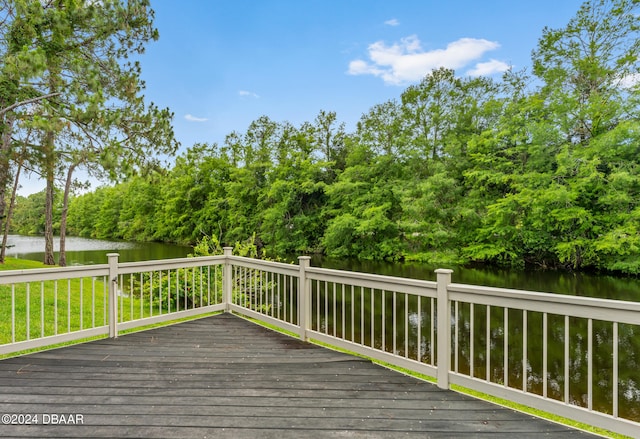 wooden terrace featuring a water view