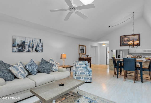 living room featuring light wood-type flooring, ceiling fan, and high vaulted ceiling