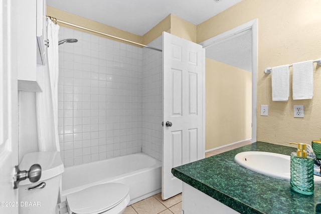 full bathroom featuring toilet, vanity, tile patterned flooring, and tiled shower / bath combo