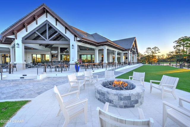 exterior space with a patio, a yard, and a fire pit