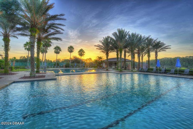 view of pool at dusk