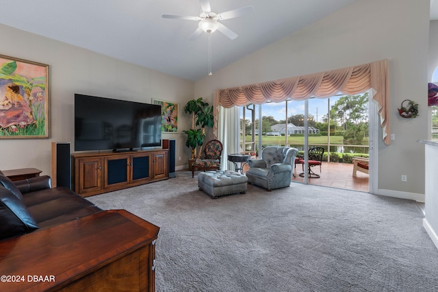 carpeted living room with ceiling fan and vaulted ceiling