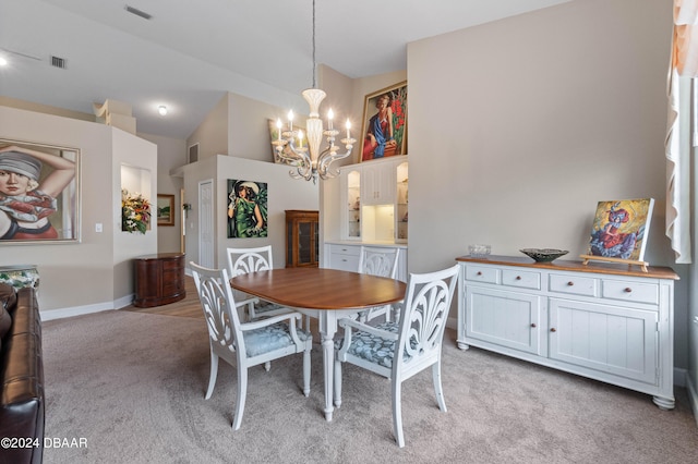 carpeted dining space featuring a chandelier and vaulted ceiling