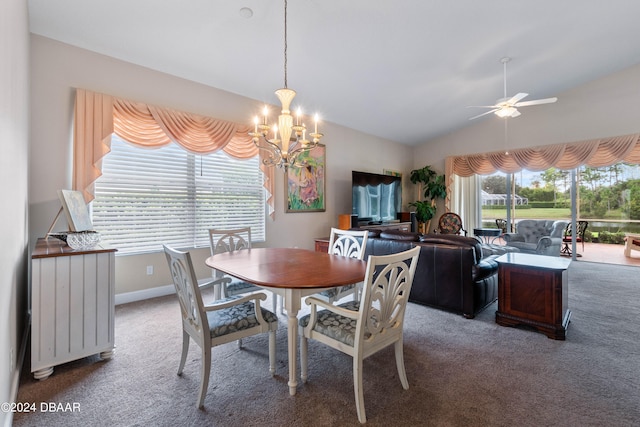 carpeted dining area featuring ceiling fan with notable chandelier and lofted ceiling