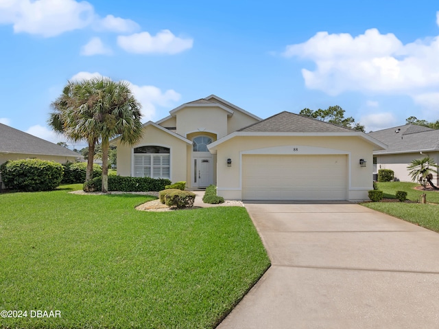 view of front of property with a garage and a front lawn